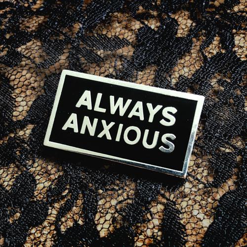 "Always Anxious" in silver block text on black enamel pin with gloss finish. Art by Print Ritual.